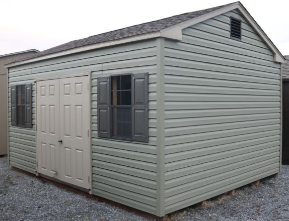 Pine Creek 12x16 HD Peak with Meadow walls, Warm Sandalwood trim and Bronze Raised Panel shutters, and Barkwood shingles